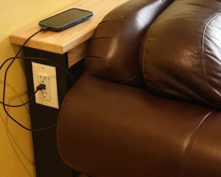 Taula sobre sofà amb presa de corrent i USB
